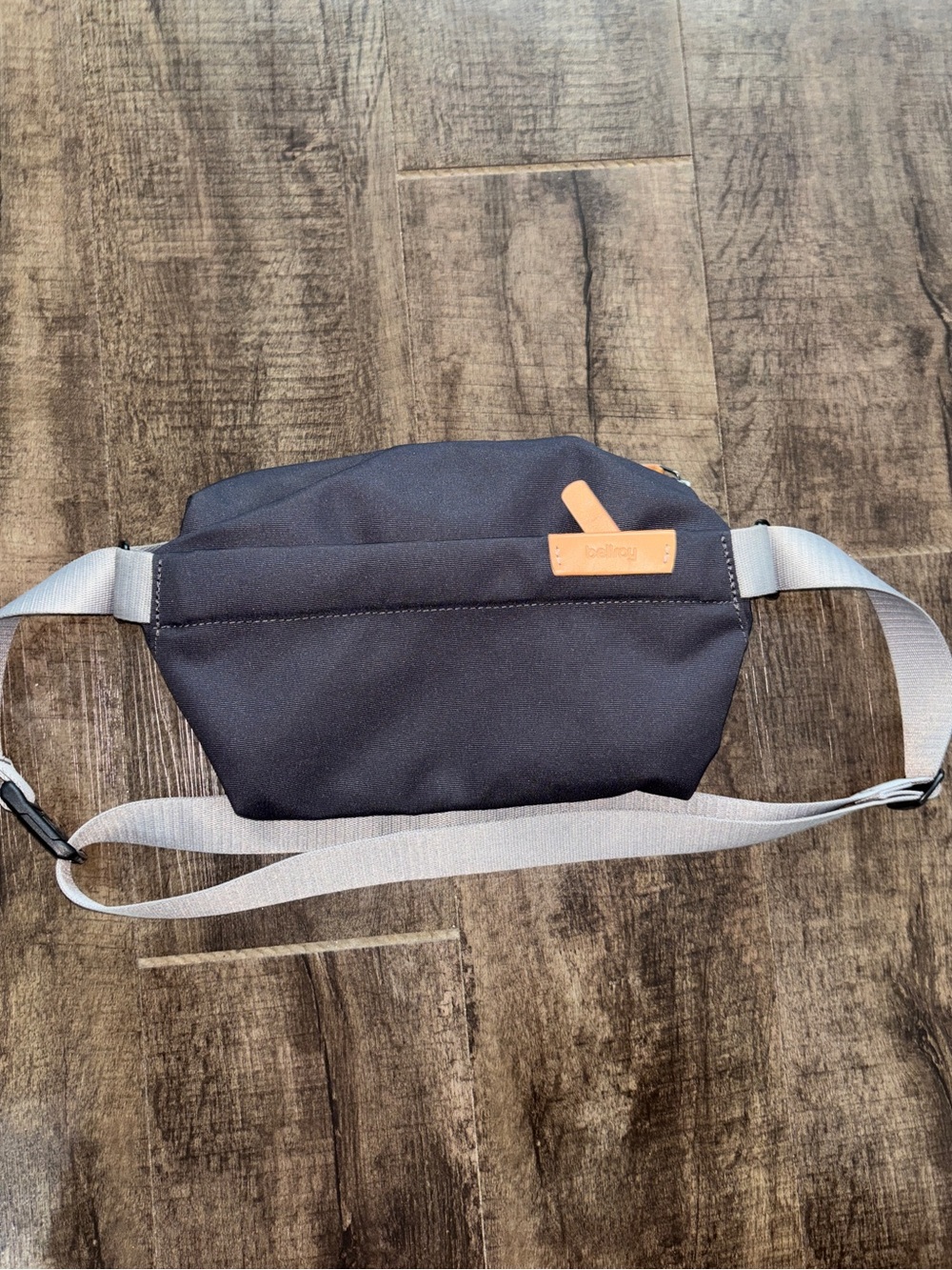 Bellroy Sling Belt Bag with Light Gray Strap and Tan Leather Tab